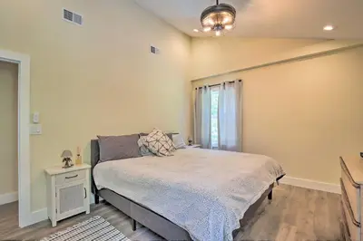 a bedroom with a large bed and a window at Modern NY Home with Views By Hudson Valley Hiking! in Hopewell Junction