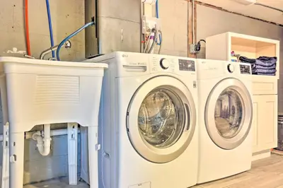 two washing machines sitting next to each other in a laundry room at Modern NY Home with Views By Hudson Valley Hiking! in Hopewell Junction