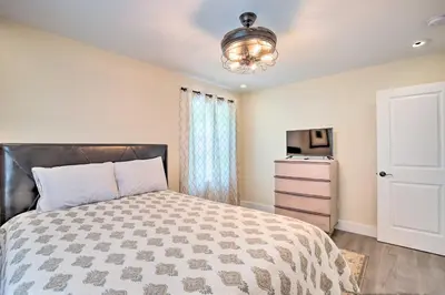 a bedroom with a bed and a television and a dresser at Modern NY Home with Views By Hudson Valley Hiking! in Hopewell Junction