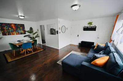 a living room with a blue couch and a table at Bright & cozy * 2nd Floor Apartment*. Close to NYC in Bloomfield