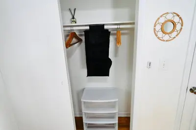 a closet with a white stool in a room at Bright & cozy * 2nd Floor Apartment*. Close to NYC in Bloomfield