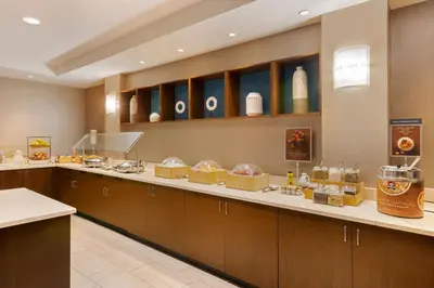 a kitchen with a counter with some food on it at SpringHill Suites by Marriott Newark International Airport in Newark
