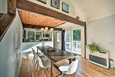 a dining room with a table and chairs at Modern Catskills Reprieve with Hot Tub and Mtn Views! in Margaretville