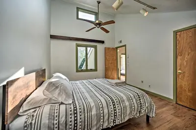 a bedroom with a bed and a ceiling fan at Modern Catskills Reprieve with Hot Tub and Mtn Views! in Margaretville