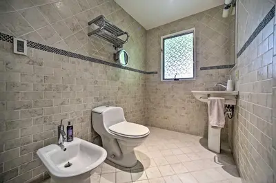 a bathroom with a toilet and a sink at Modern Catskills Reprieve with Hot Tub and Mtn Views! in Margaretville