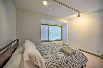 a bedroom with a bed and a window at Modern Catskills Reprieve with Hot Tub and Mtn Views! in Margaretville