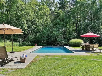 a swimming pool with an umbrella and tables and chairs at Summer and Fall in Sheffield with Monthly Special Pricing Available in Sheffield