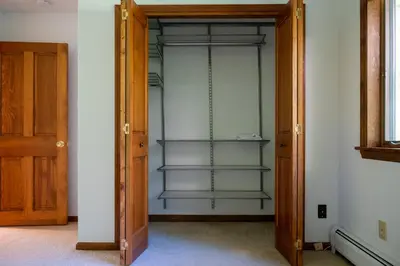 an open door to a closet with glass shelves at Summer and Fall in Sheffield with Monthly Special Pricing Available in Sheffield