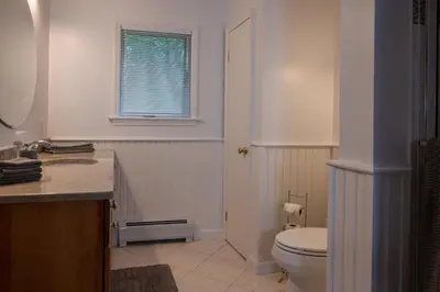 a bathroom with a toilet and a sink and a window at Summer and Fall in Sheffield with Monthly Special Pricing Available in Sheffield