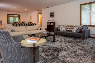 a living room with two couches and a table at Summer and Fall in Sheffield with Monthly Special Pricing Available in Sheffield