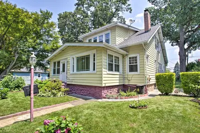 a small yellow house with a yard at Charming Yonkers Retreat - 10 Mi to Central Park! in Yonkers