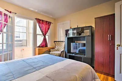 a bedroom with a bed and a tv and a chair at Charming Yonkers Retreat - 10 Mi to Central Park! in Yonkers