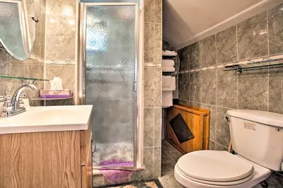 a bathroom with a toilet and a sink and a shower at Charming Yonkers Retreat - 10 Mi to Central Park! in Yonkers