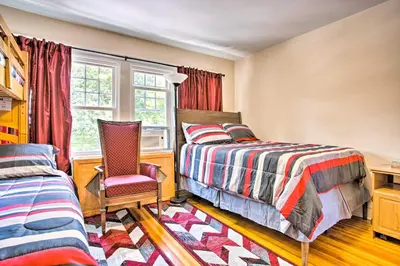 a bedroom with a bed and a chair and a desk at Charming Yonkers Retreat - 10 Mi to Central Park! in Yonkers