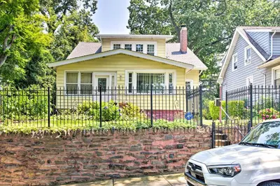 a white car parked in front of a yellow house at Charming Yonkers Retreat - 10 Mi to Central Park! in Yonkers