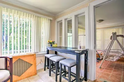 a home office with a blue table and stools at Charming Yonkers Retreat - 10 Mi to Central Park! in Yonkers