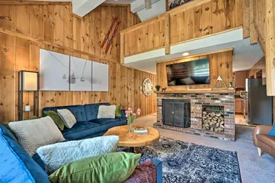 a living room with a blue couch and a fireplace at Relaxing Mountain Refuge 4 Miles to Mt Snow! in Dover