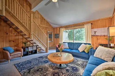 a living room with a blue couch and a table at Relaxing Mountain Refuge 4 Miles to Mt Snow! in Dover
