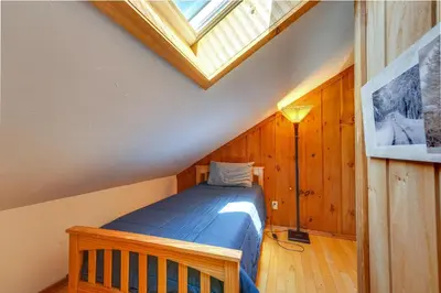 a bedroom with a bed and a skylight at Relaxing Mountain Refuge 4 Miles to Mt Snow! in Dover