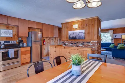a kitchen with wooden cabinets and a table with chairs at Relaxing Mountain Refuge 4 Miles to Mt Snow! in Dover
