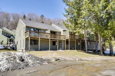 a large house with a balcony and trees at Relaxing Mountain Refuge 4 Miles to Mt Snow! in Dover