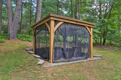 a wooden gazebo in the middle of a field at Steps to Lake Tafton Cottage with Fire Pit and Grill in Tafton