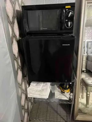 a microwave oven sitting on top of a shelf at Nice Cozy Room By Empire City Casino And Cross County Mall in Yonkers