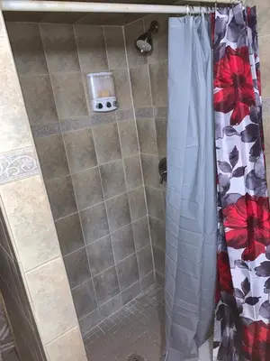 a bathroom with a shower with a shower curtain at Nice Cozy Room By Empire City Casino And Cross County Mall in Yonkers
