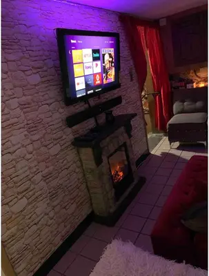 a living room with a tv and a fireplace at Nice Cozy Room By Empire City Casino And Cross County Mall in Yonkers