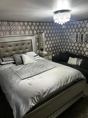 a bedroom with a large bed and a chandelier at Nice Cozy Room By Empire City Casino And Cross County Mall in Yonkers