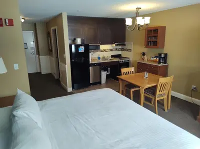 a bedroom with a bed and a kitchen with a table at Grand Summit Resort, A Vail Resorts Property in Dover