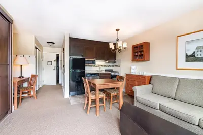 a kitchen and living room with a couch and a table at Grand Summit Resort, A Vail Resorts Property in Dover