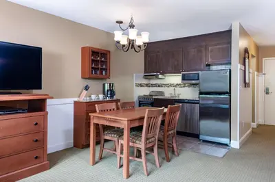 a kitchen with a table and chairs and a refrigerator at Grand Summit Resort, A Vail Resorts Property in Dover