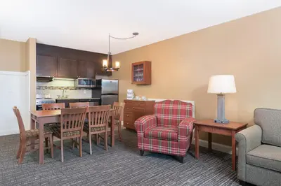 a living room and kitchen with a table and chairs at Grand Summit Resort, A Vail Resorts Property in Dover