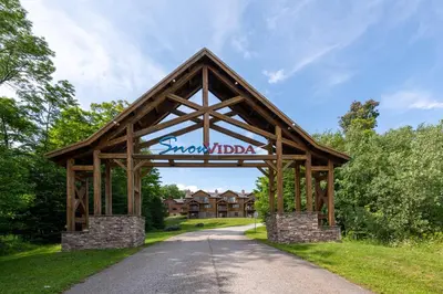 a pavilion with a sign in the middle of a road at Mount Snow Lodging by Vail Resorts in Dover