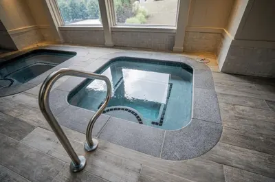 a jacuzzi tub in the middle of a room at Mount Snow Lodging by Vail Resorts in Dover