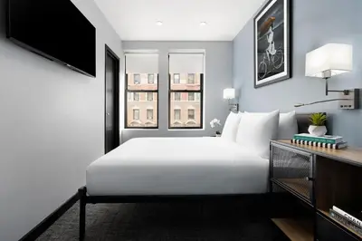 a bedroom with a white bed and a window at OYO Times Square in New York