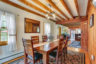 a dining room with a wooden table and chairs at Game Room and Yard Greentown Home Near State Park in Greentown