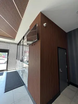 a room with a wooden wall and a door at Capital Hotel Long Island City in Queens