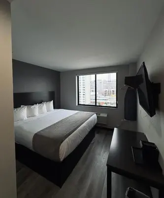 a hotel room with a bed and a window at Capital Hotel Long Island City in Queens
