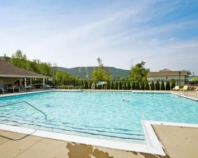 a large swimming pool with blue water at Vacation Village in the Berkshires in Hancock