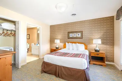 a bedroom with a large bed and a bathroom at Vacation Village in the Berkshires in Hancock