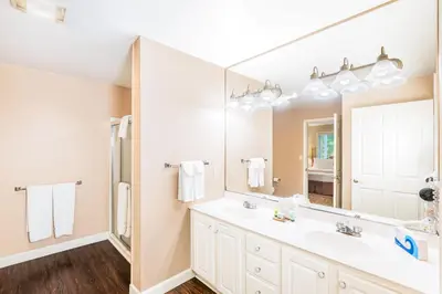 a bathroom with a sink and a large mirror at Vacation Village in the Berkshires in Hancock