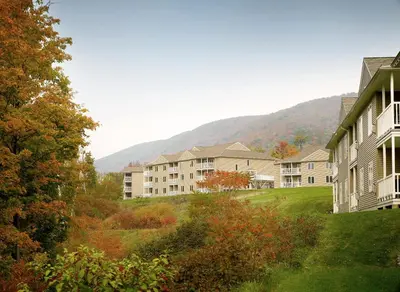a row of apartment buildings with mountains in the background at Vacation Village in the Berkshires in Hancock