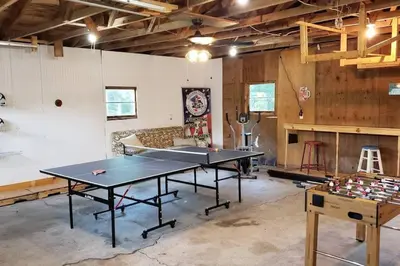 a ping pong room with a ping pong table in it at Southwoods Mountain Estate -private mansion, pool, hottub+ 15 acres in Monticello