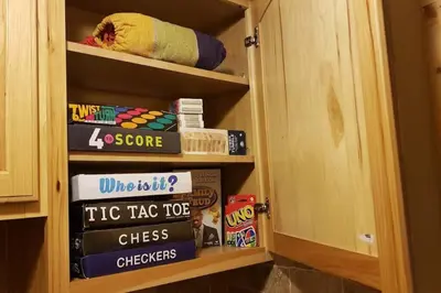 a book shelf filled with lots of books at Southwoods Mountain Estate -private mansion, pool, hottub+ 15 acres in Monticello