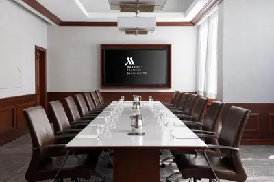 a conference room with a long table and chairs at Teaneck Marriott at Glenpointe in Teaneck