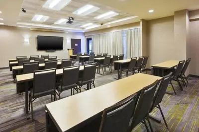 a conference room with tables and chairs and a tv at Courtyard by Marriott Secaucus Meadowlands in Secaucus
