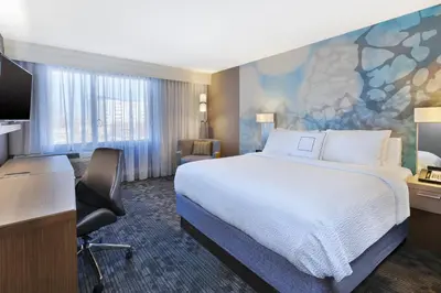 a hotel room with a large bed and a desk at Courtyard by Marriott Secaucus Meadowlands in Secaucus