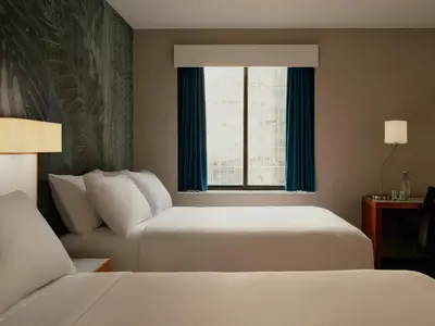 a hotel room with two beds and a window at The Cloud One New York-Downtown, by the Motel One Group in New York